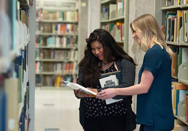 Two women looking over a book